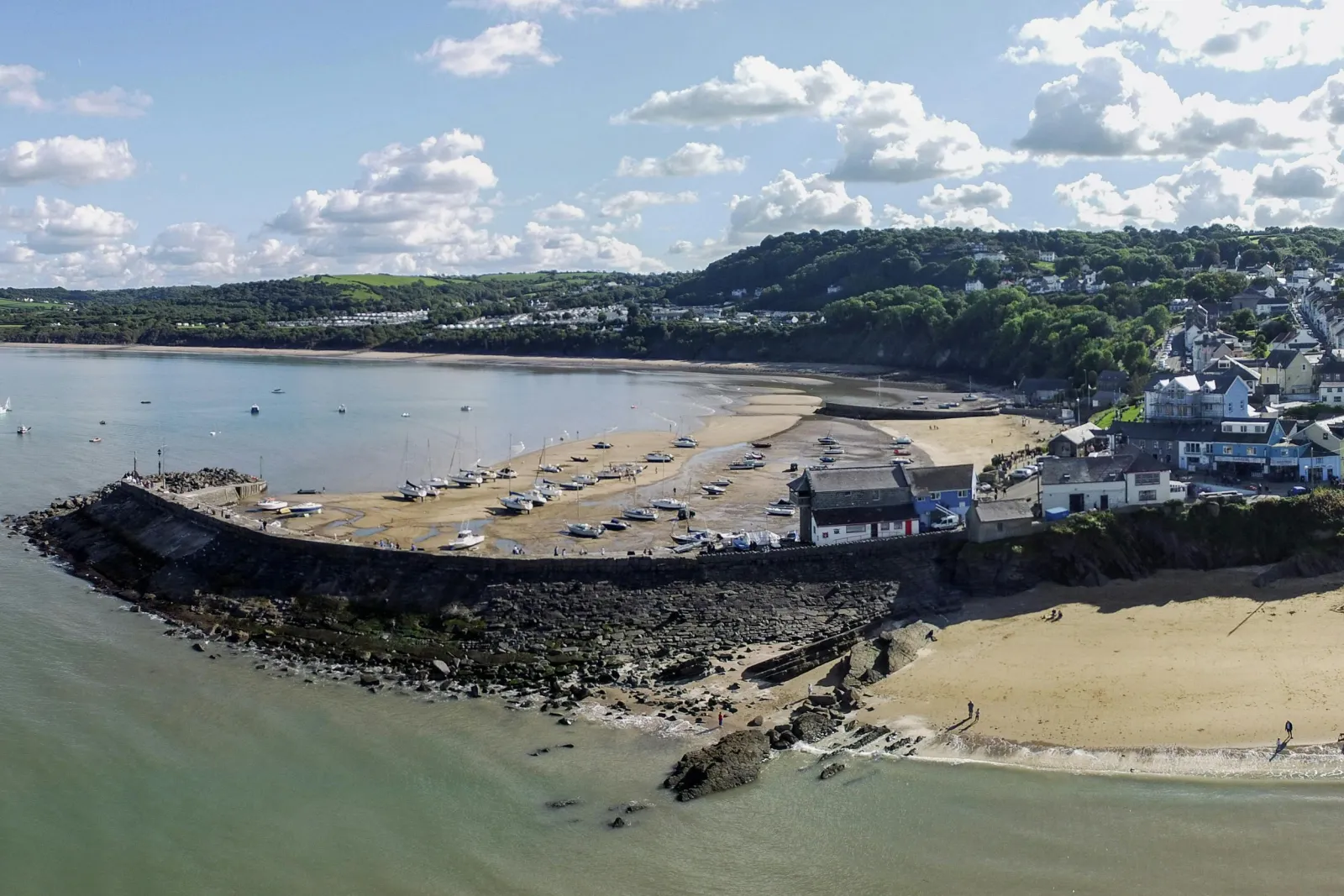 View of New Quay from the sea with beaches and harbour wall