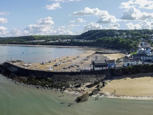 View of New Quay from the sea with beaches and harbour wall