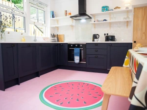 Kitchen with base cupboards and open shelves. Table and chairs