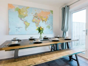 Map of the world on the wall, table and benches laid for lunch