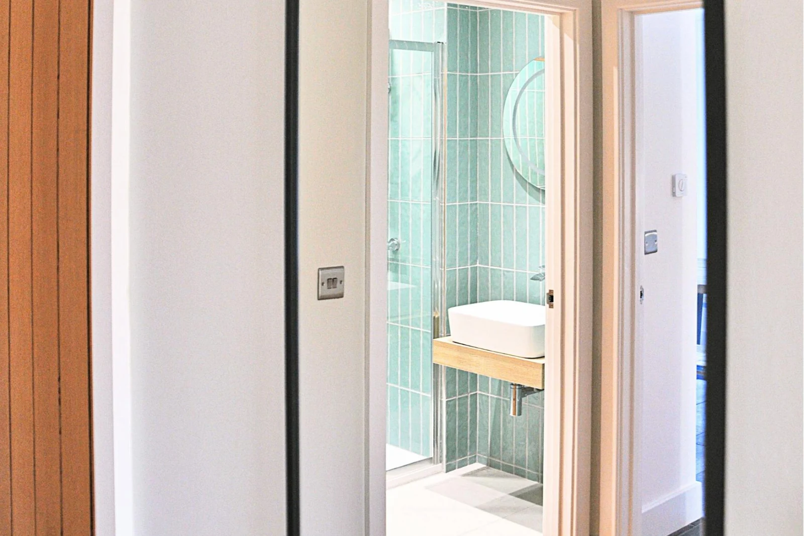 Walk in shower cubicle, wash hand basin with mirror over