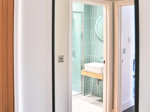 Walk in shower cubicle, wash hand basin with mirror over