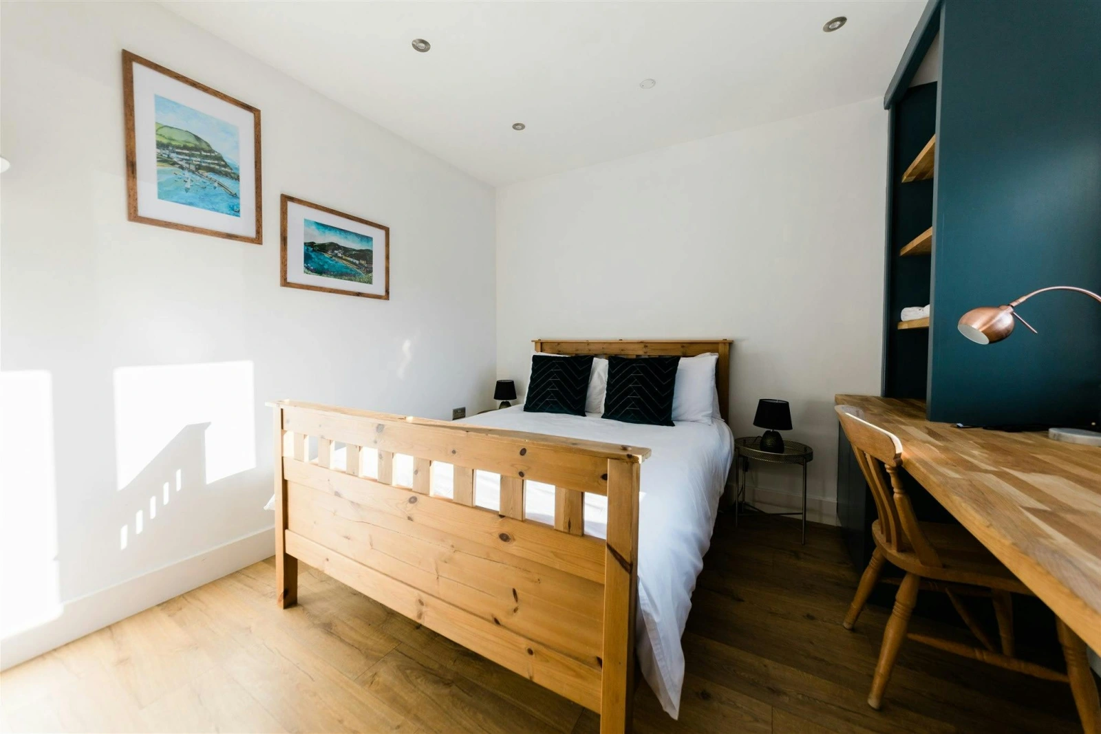 Kind size bed with cushions, bedside cabinets and lamps, chair and dressing table