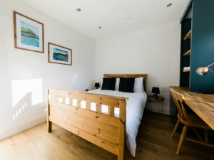 Kind size bed with cushions, bedside cabinets and lamps, chair and dressing table