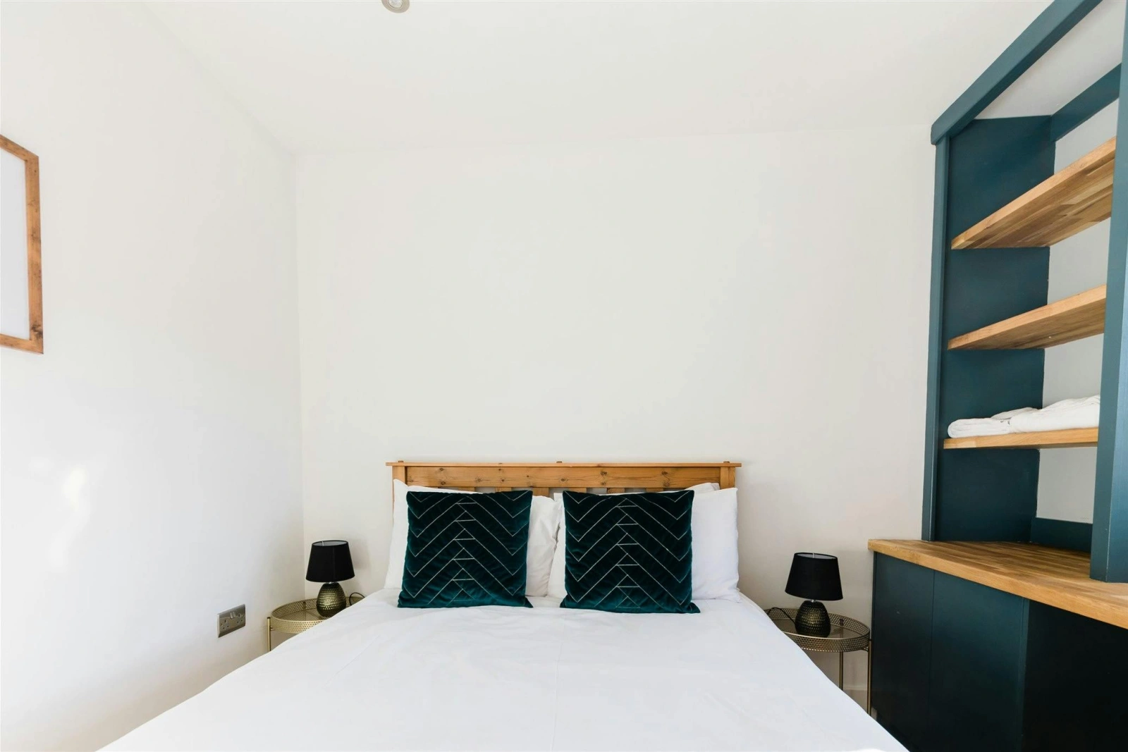 Kind size bed with cushions, shelving