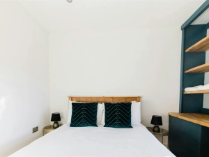 Kind size bed with cushions, shelving