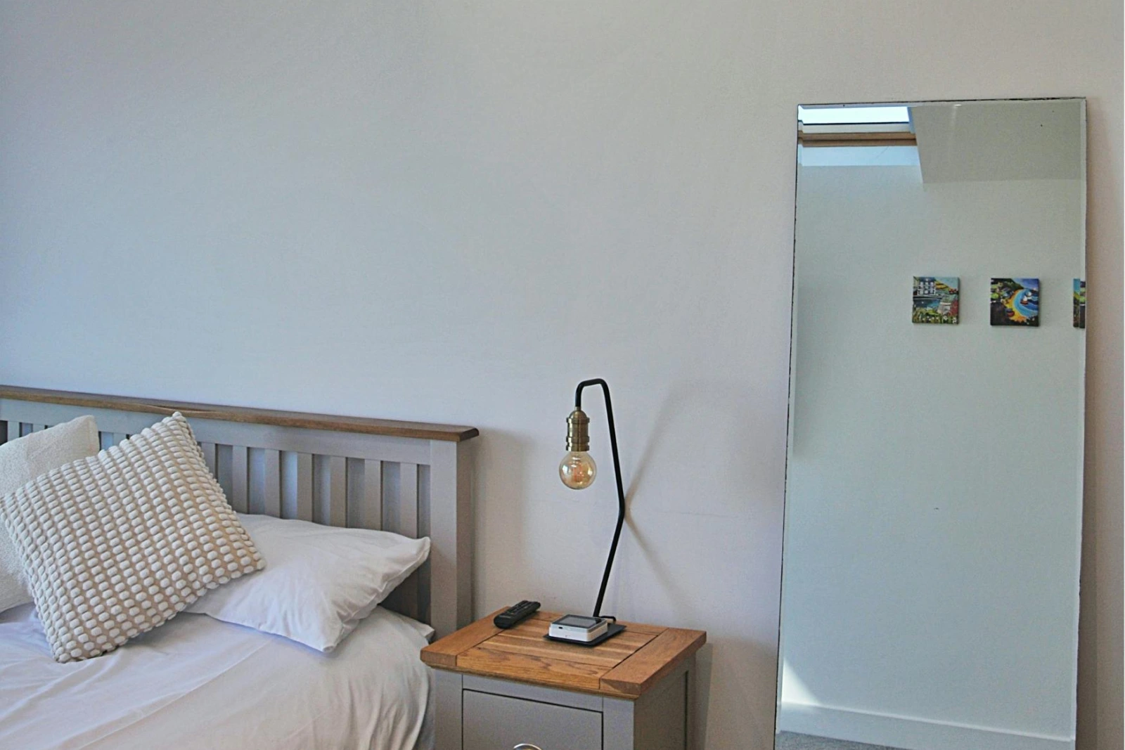 Full length mirror. Bedside table and lamp