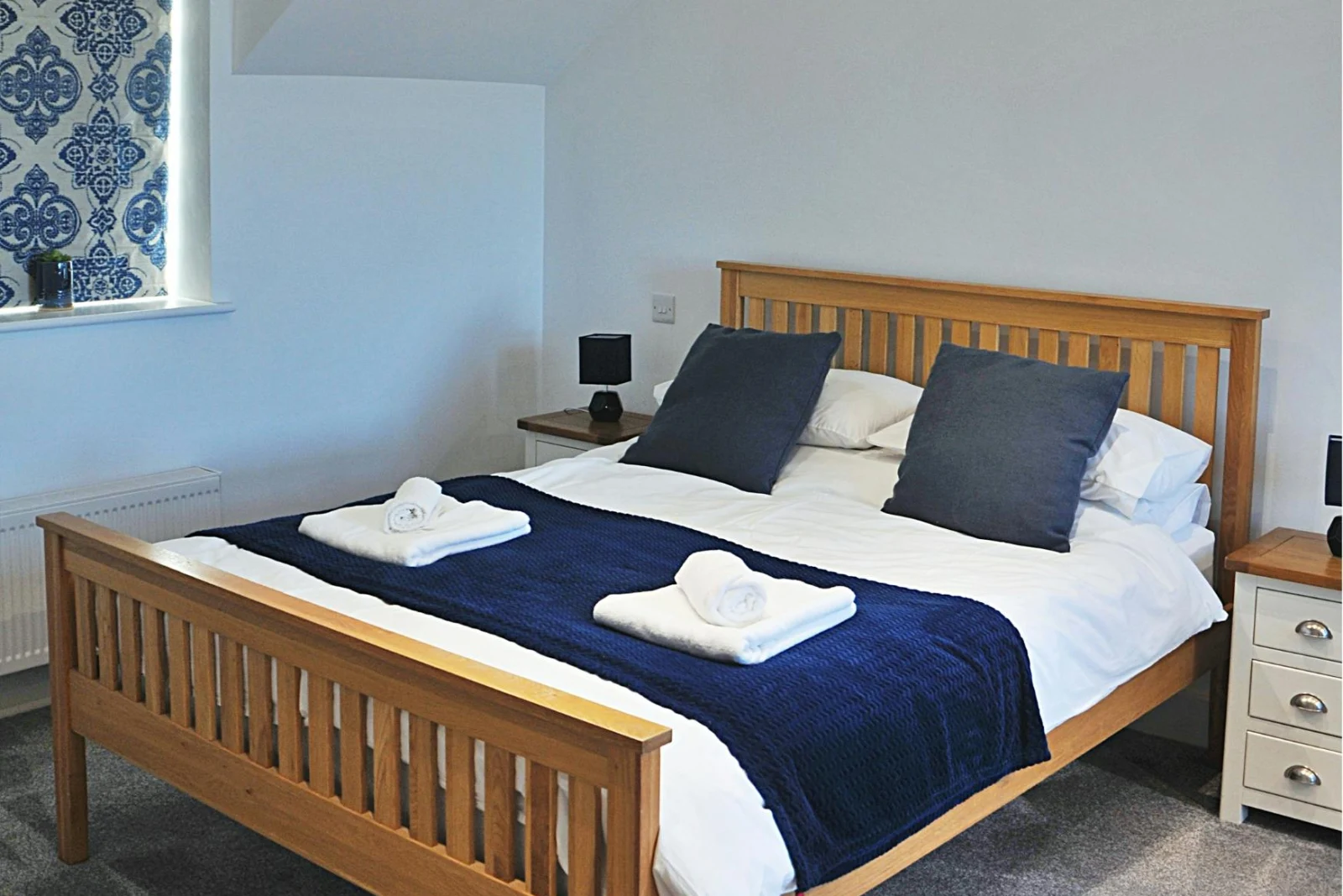 King size bed  with bedside cupboards and lamps