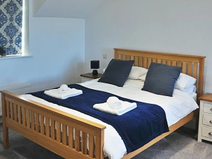 King size bed  with bedside cupboards and lamps