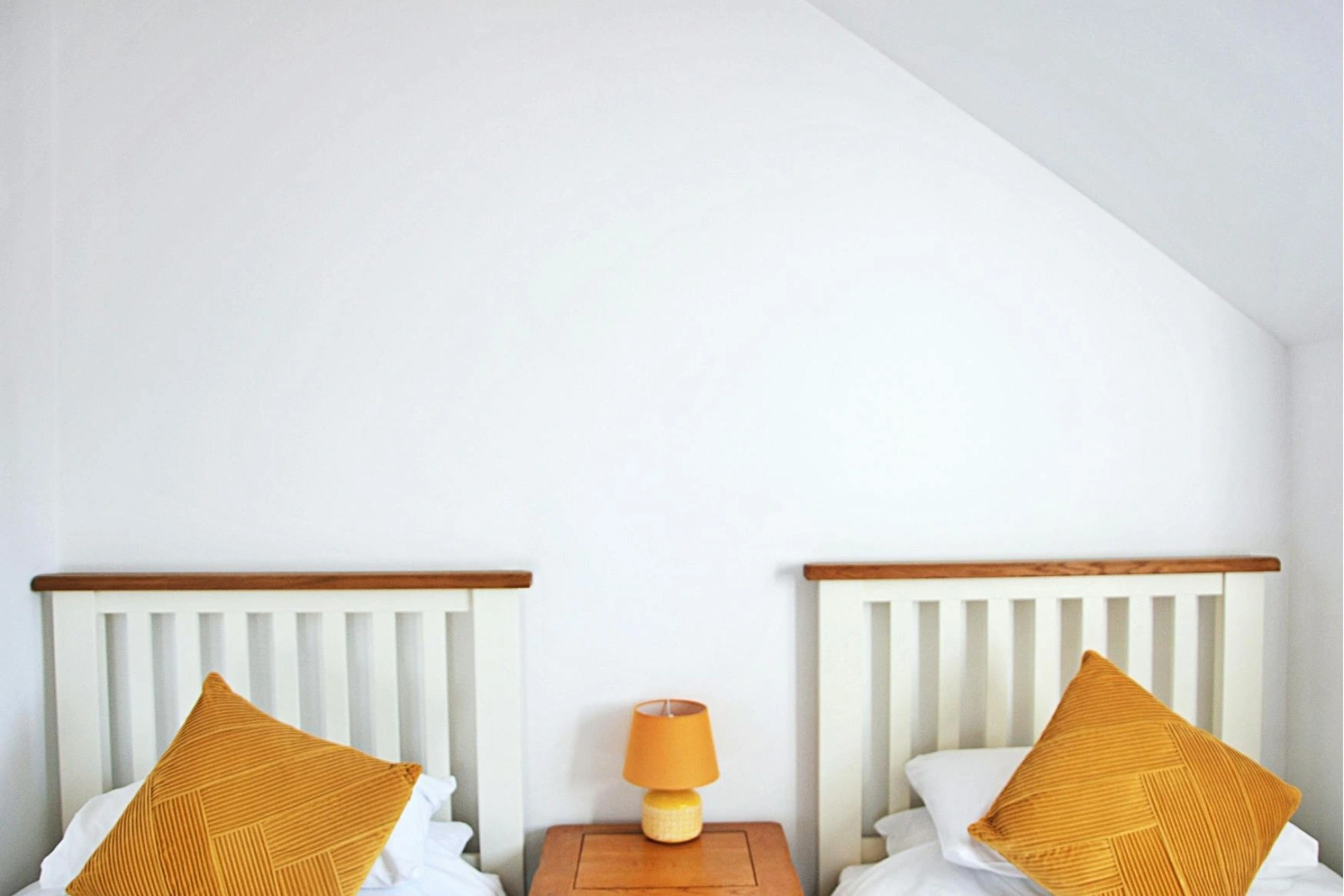 Twin beds with bedside table and lamp
