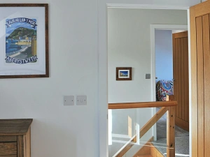 The landing area with glass panelled stairs