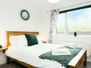 Double bedroom with bedside shelves and lamps