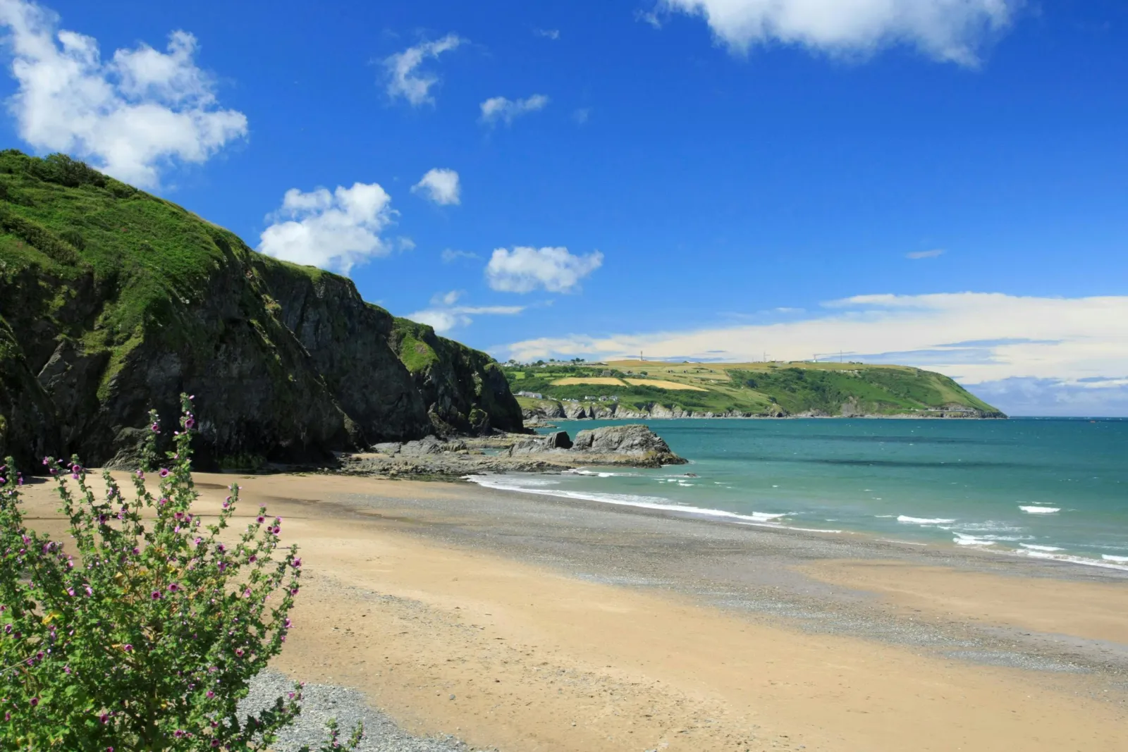 Tresaith sandy beach with sea and rocky headlands beyond