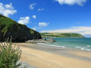 Tresaith sandy beach with sea and rocky headlands beyond