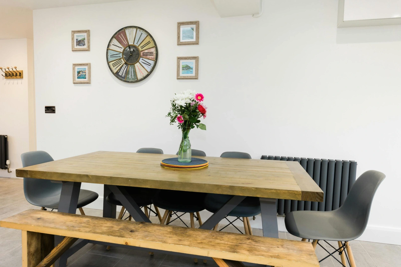 Dining table in the kitchen. flower vase on top.
