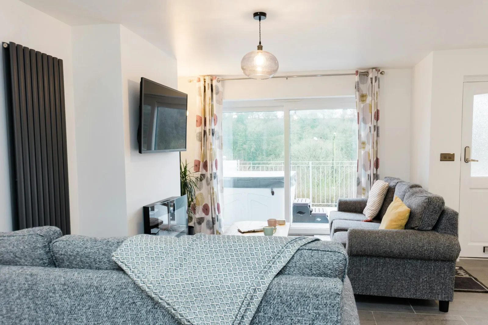 Living room with 2 sofas and wall heater.