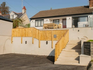 Front of the house with steps leading up to the property.