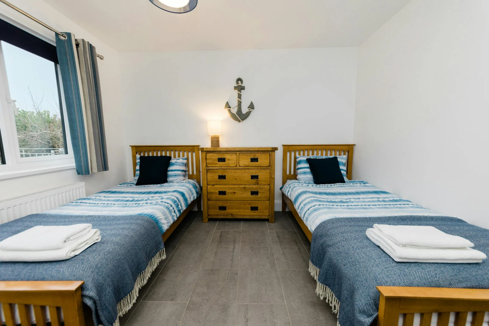Twin bedroom with single beds and bedside tables.