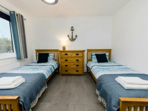 Twin bedroom with single beds and bedside tables.
