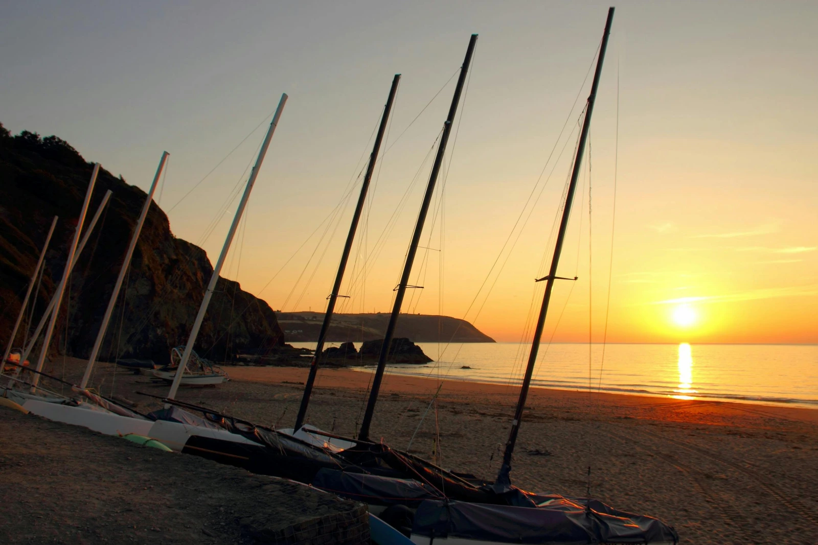 Sailing ships on the beach at Tresaith at Sunset