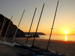 Sailing ships on the beach at Tresaith at Sunset