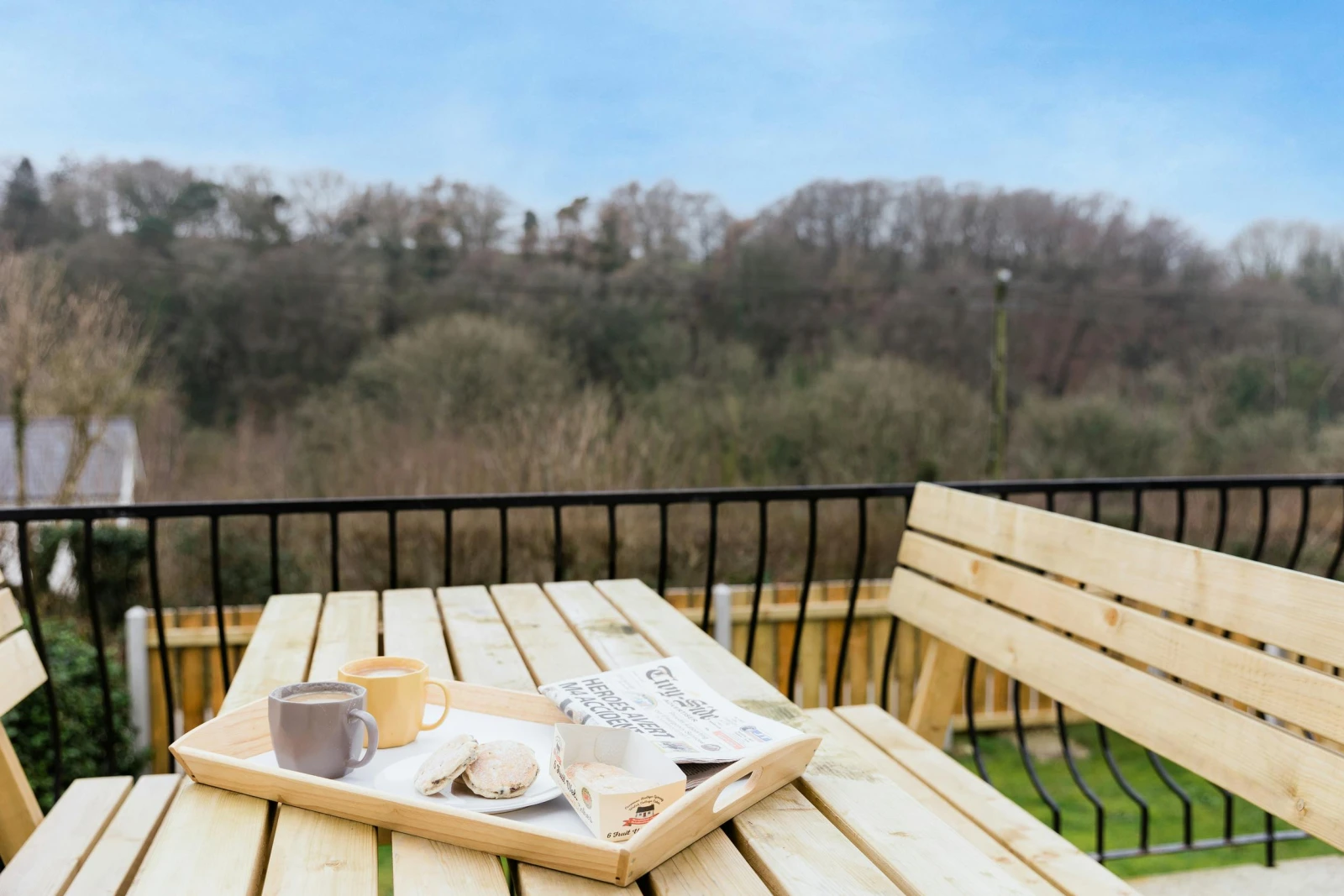 Wooden food bench on the outside balcony with views looking down to the garden.