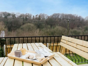 Wooden food bench on the outside balcony with views looking down to the garden.