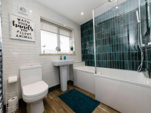 Bathroom with bath tub, shower, toilet, sink and towel warmer.