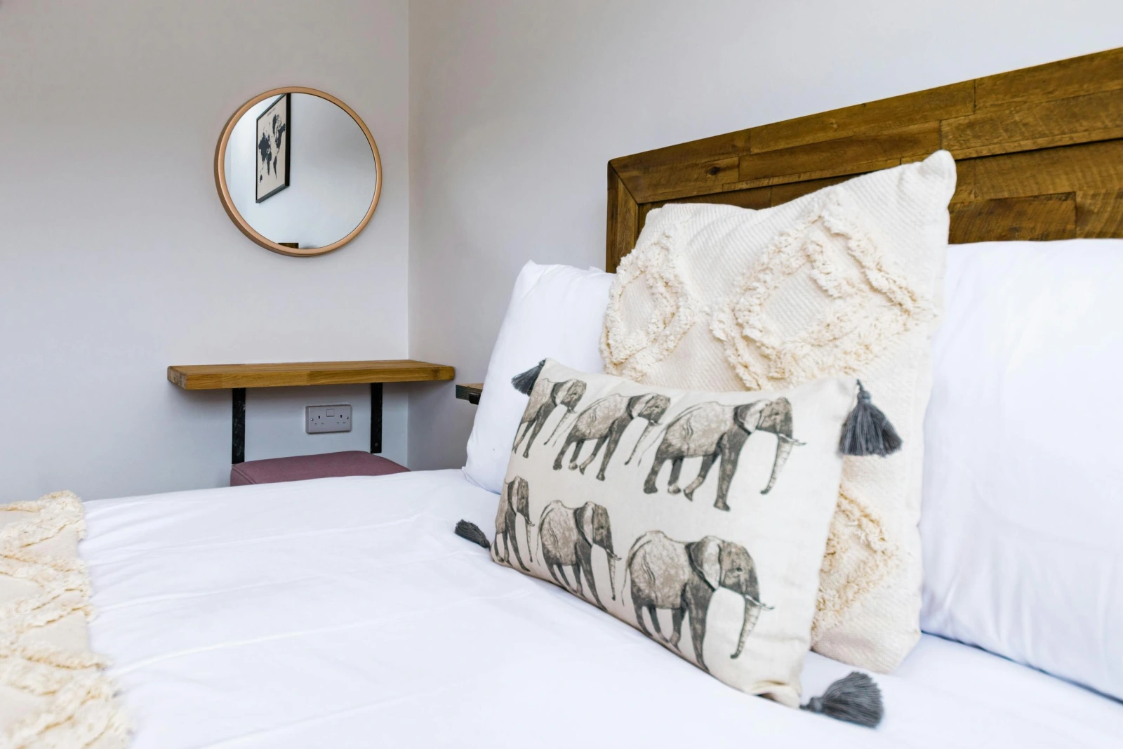 Bedroom with laminated wood flooring, single bed, wall mirror, desk and chair.