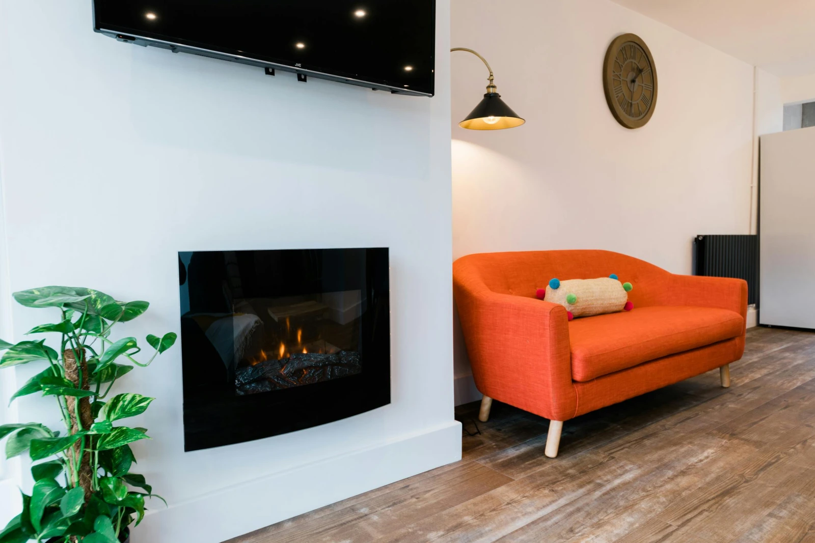 TV on the wall, electric fire and sofa