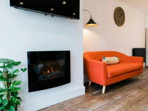 TV on the wall, electric fire and sofa