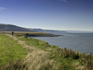 Person walking along the coast path near Llanrhystud