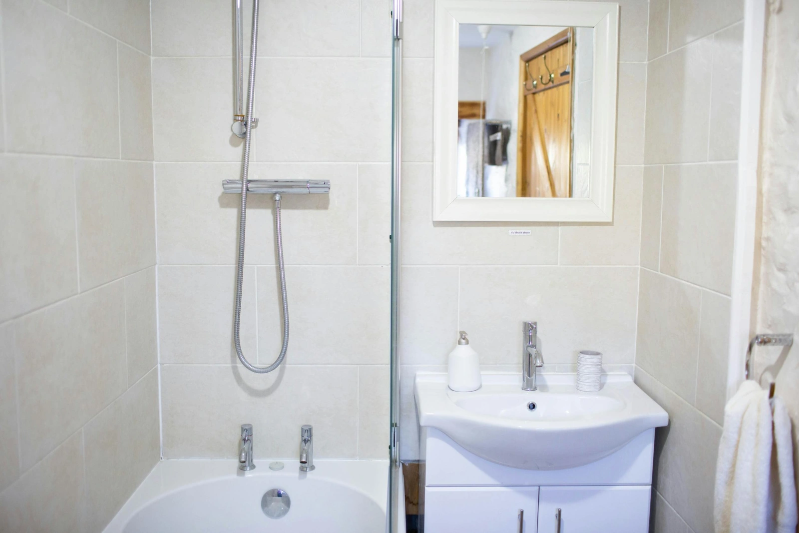Fully lied bathroom. Bath with shower over and shower screen. Wash hand basin