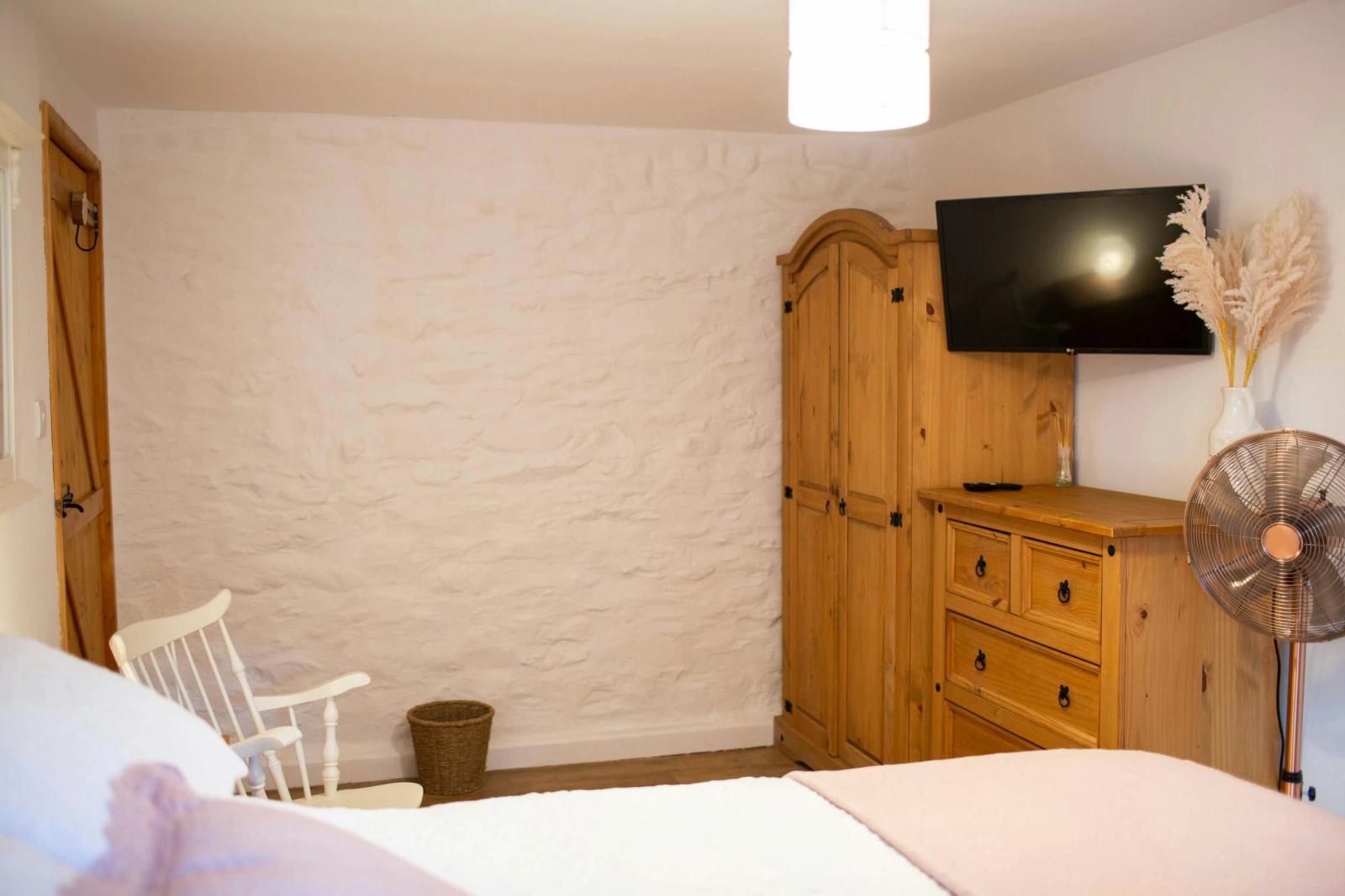 Wall mounted TV. Wardrobe and chest of drawers