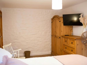Wall mounted TV. Wardrobe and chest of drawers