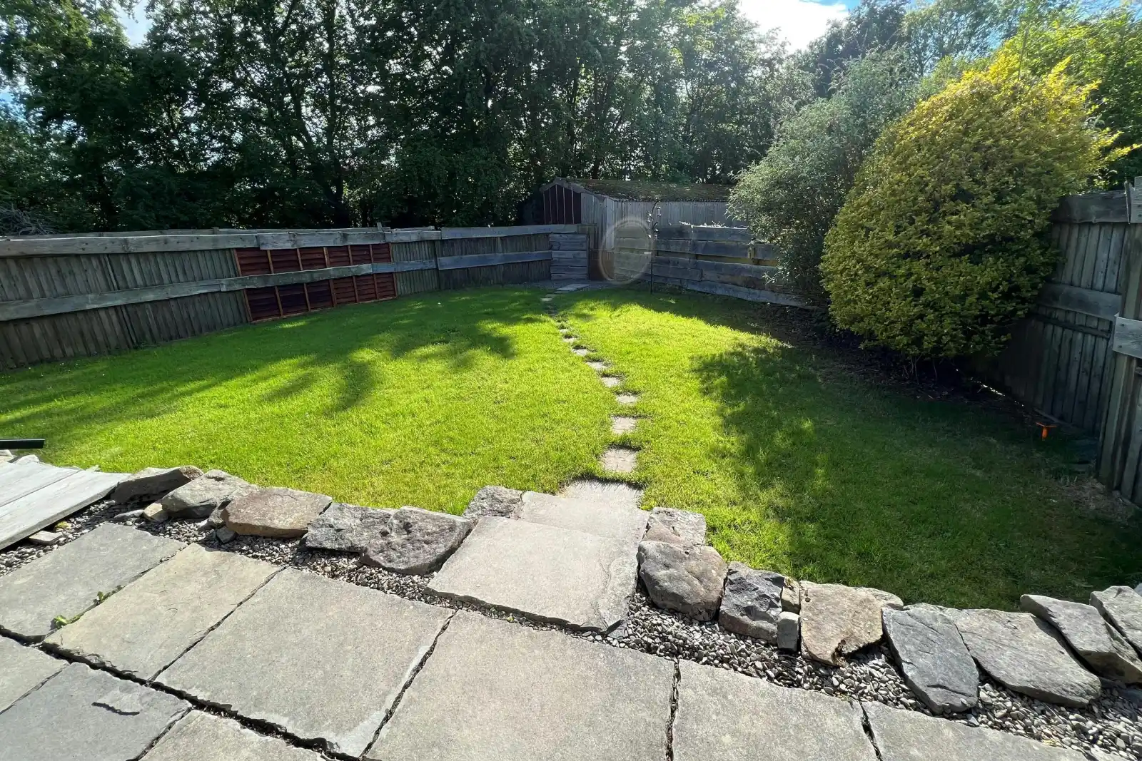 Stone patio leading to lawn area
