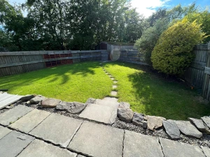 Stone patio leading to lawn area