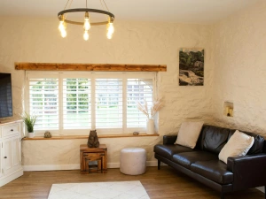 Sitting room with large window with blinds