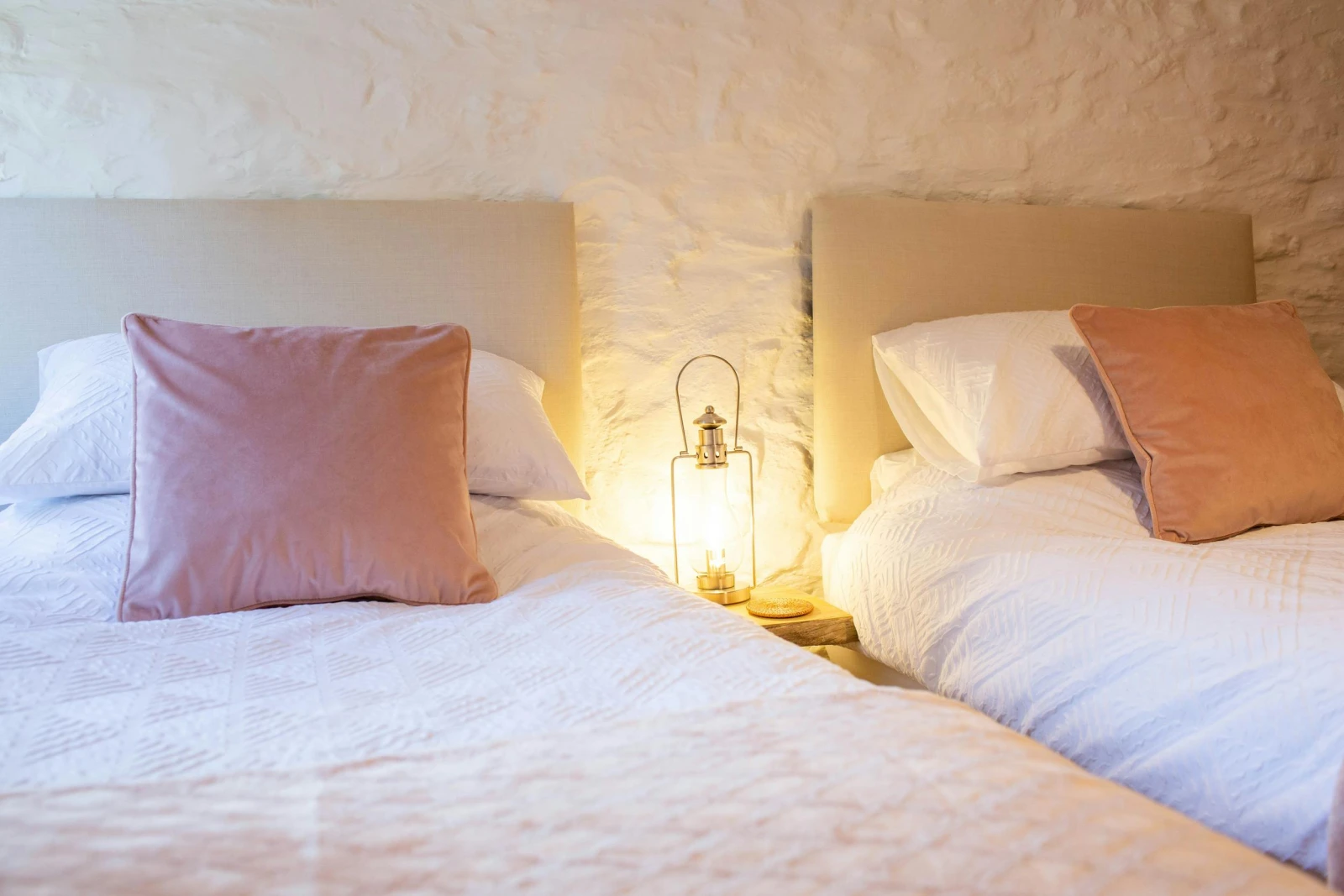 Twin beds with beside table and lamp
