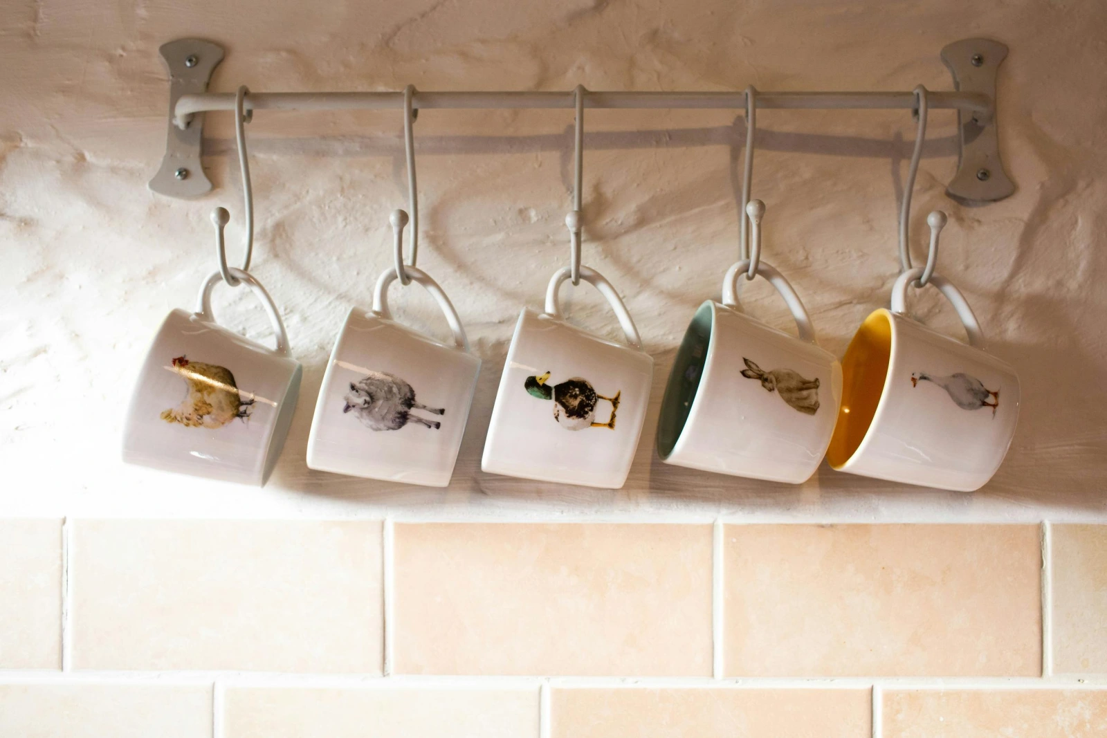 Mug rack on wall with mugs with animals printed on