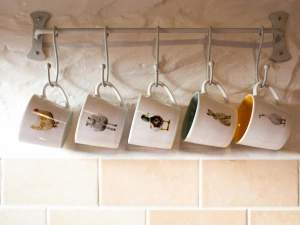 Mug rack on wall with mugs with animals printed on