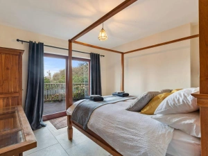 Four poster bed with French doors leading onto the terrace with sea views