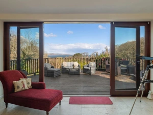 Armchair and telescope leading to terrace with patio furniture