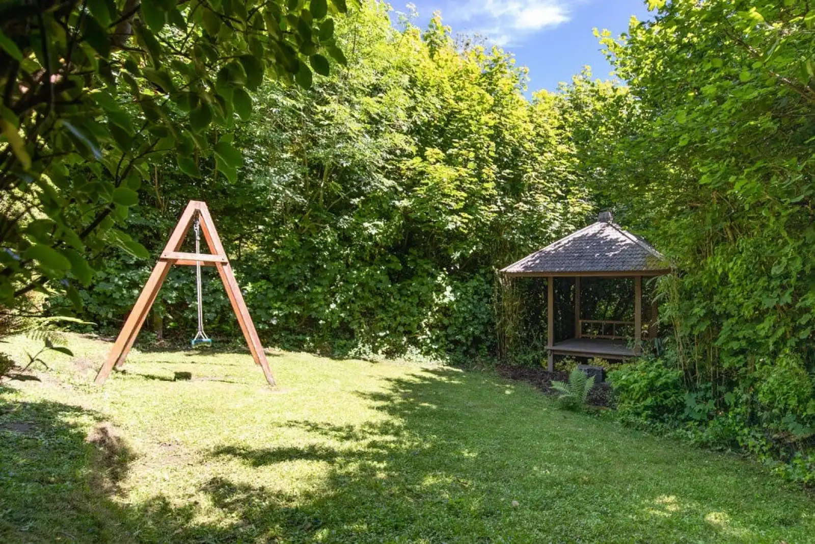Lawn area with garden swing and covered seating area