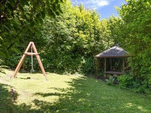 Lawn area with garden swing and covered seating area