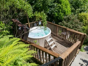 Steps leading from the terrace to a deck with hot tub on