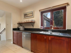 Kitchen with tiled floors and steps leading to the living accommodation