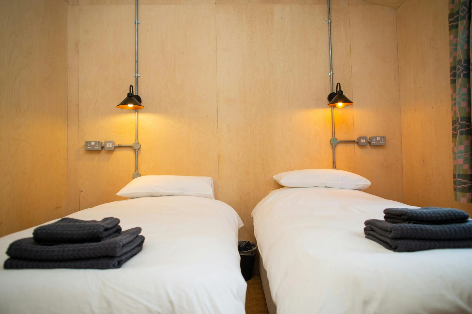 Twin single beds with wall mounted reading lights