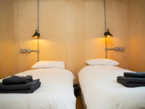 Twin single beds with wall mounted reading lights