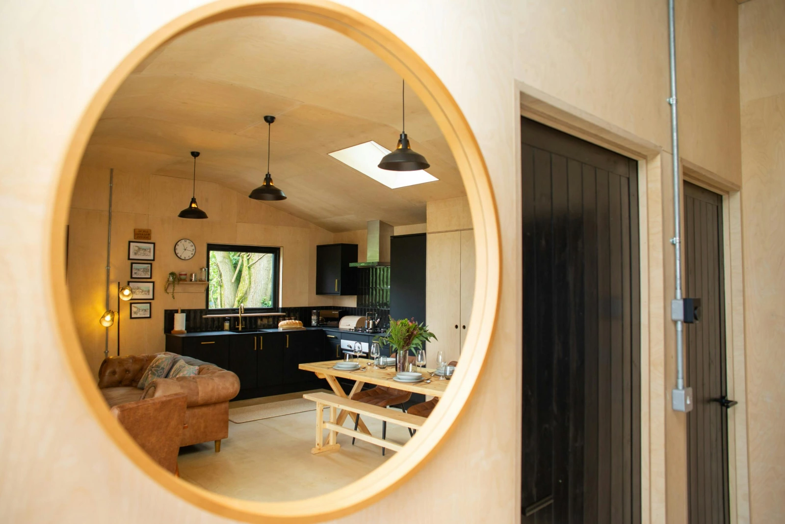 Wall mounted mirror with the reflection of the kitchen, living and dining area